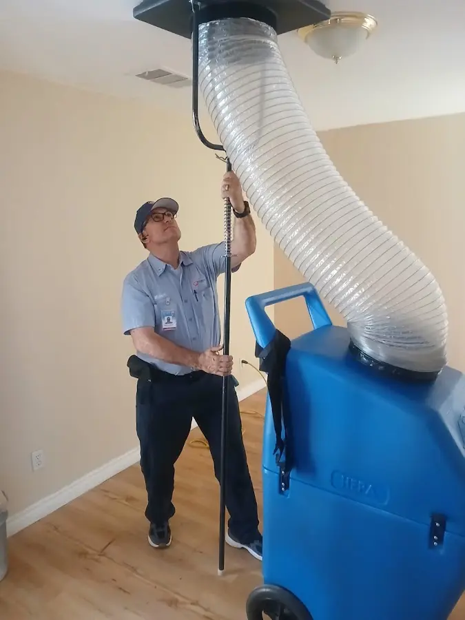 Furnace Tune-Up technician using HEPA equipment in Ada